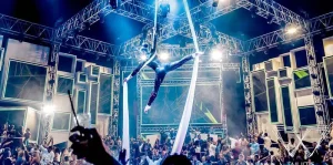 Aerial silk performer above energetic crowd at WHITE Dubai nightclub