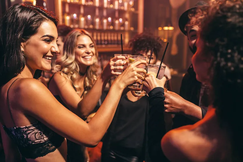 Paris Nightlife Models – Club iLL Repute Group of glamorous models raising cocktails in a chic Paris nightclub